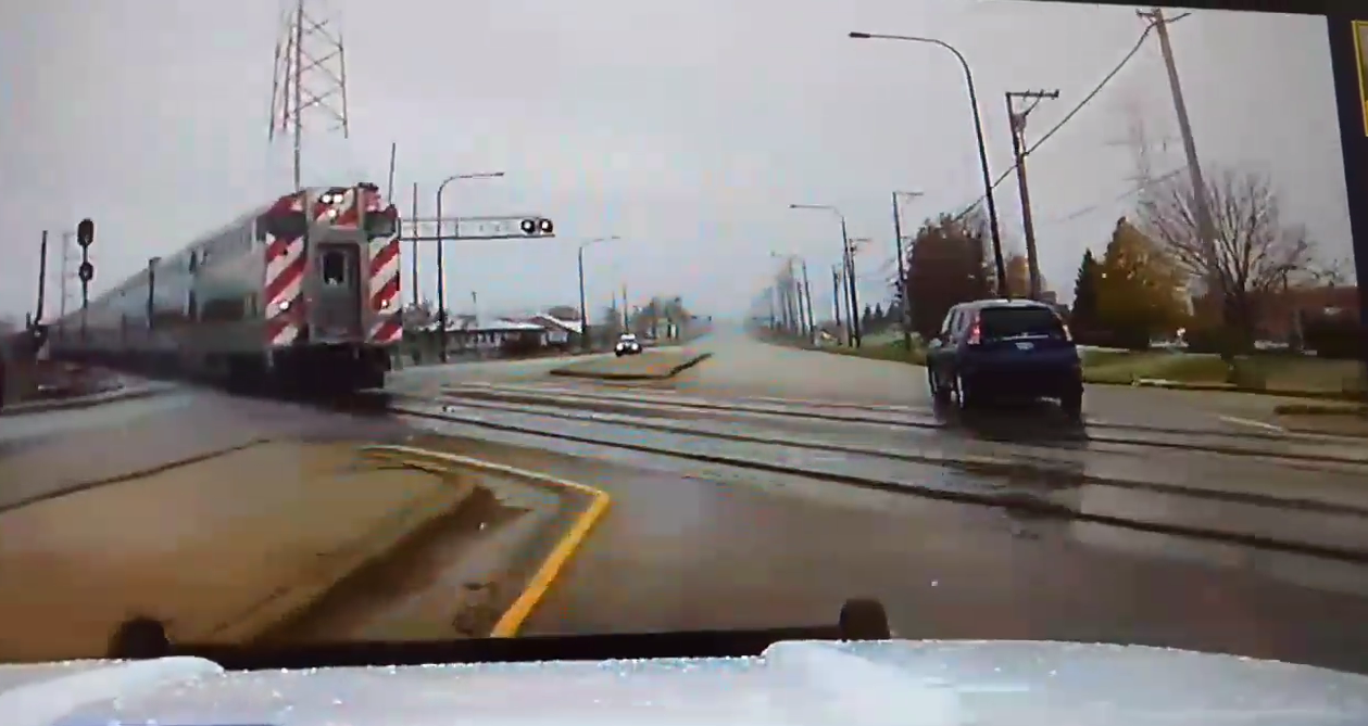 Train almost hits cop car